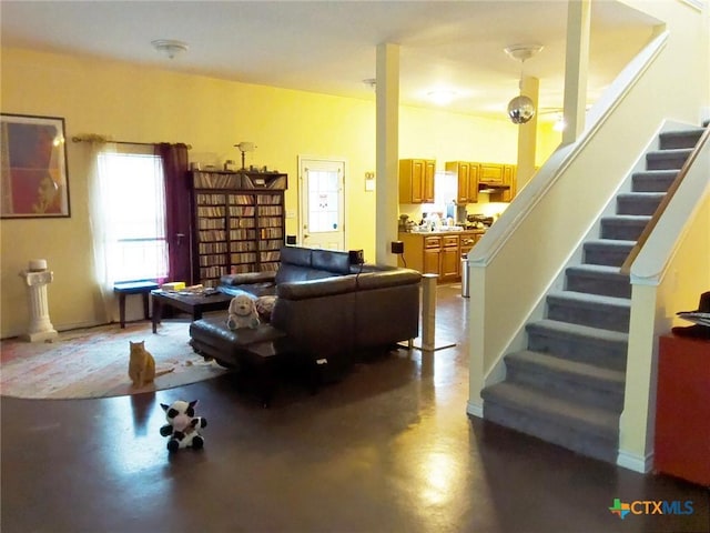 618 Pecos St, Lockhart, TX 78644 - living room featuring stairway and finished concrete floors