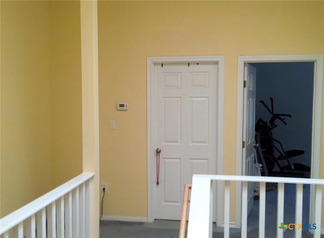 618 Pecos St, Lockhart, TX 78644 - hallway with baseboards, an upstairs landing, and carpet floors