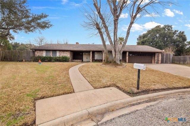 ranch-style house with a garage and a front lawn