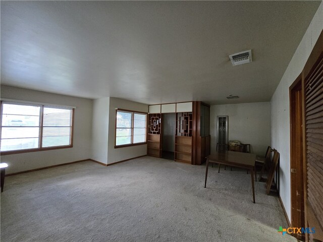 220 Davis Ave, Port Lavaca, TX 77979 - unfurnished living room with carpet flooring and baseboards