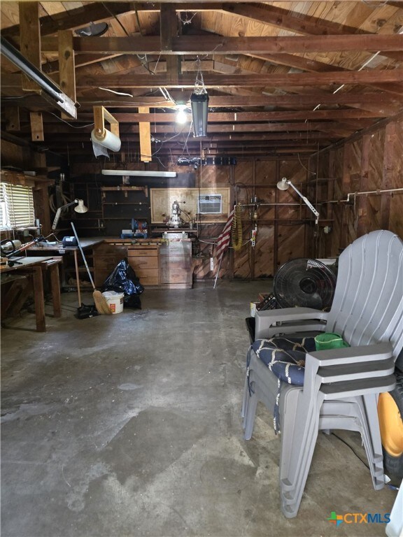 220 Davis Ave, Port Lavaca, TX 77979 - garage featuring a workshop area and wood walls