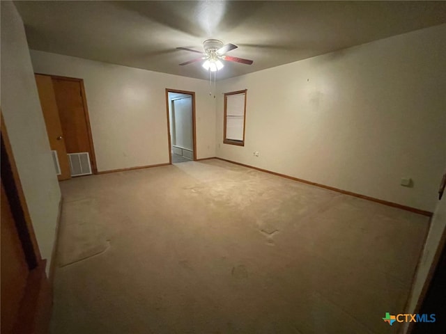 220 Davis Ave, Port Lavaca, TX 77979 - unfurnished bedroom with baseboards, light carpet, and ceiling fan