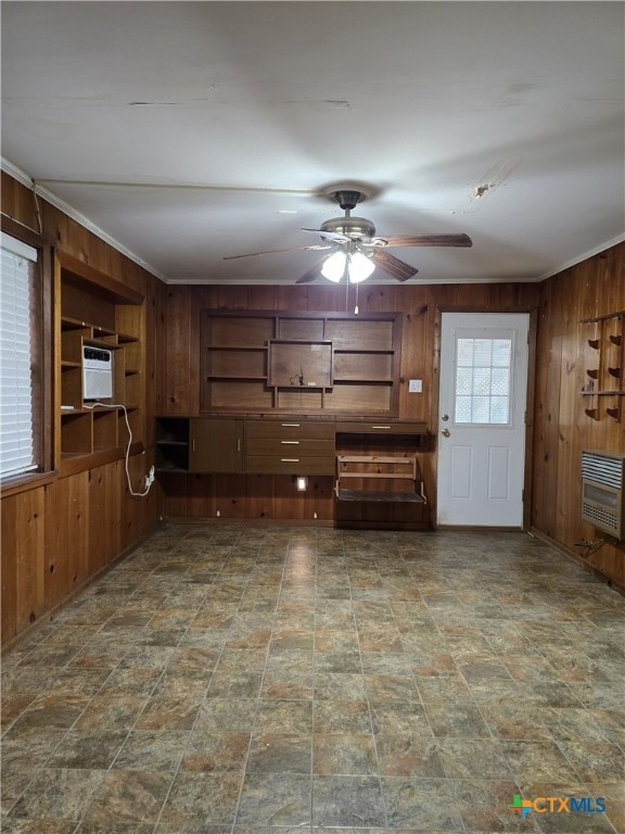 220 Davis Ave, Port Lavaca, TX 77979 - unfurnished living room with wood walls, heating unit, and ceiling fan