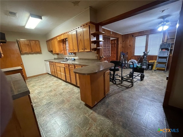 220 Davis Ave, Port Lavaca, TX 77979 - kitchen with open shelves, ceiling fan, a sink, brown cabinetry, and a peninsula