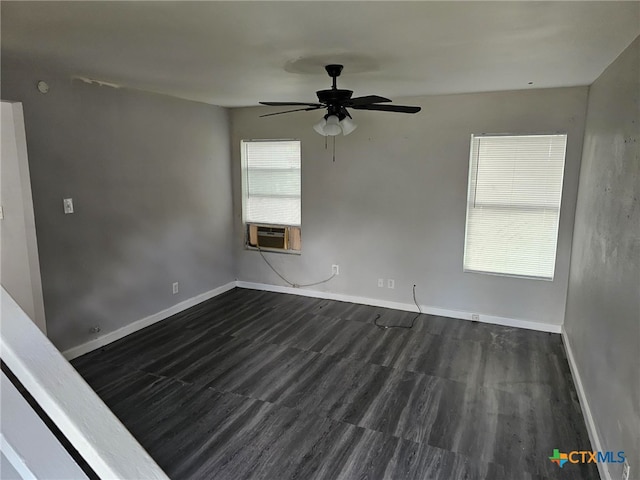 unfurnished room featuring ceiling fan, dark hardwood / wood-style floors, plenty of natural light, and cooling unit