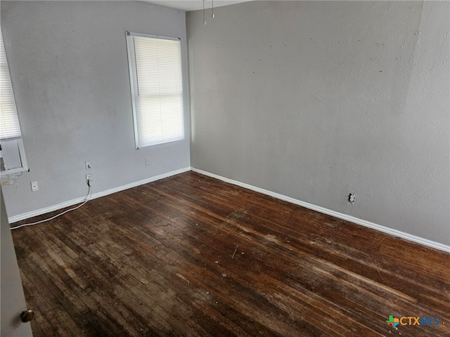 empty room with dark hardwood / wood-style flooring