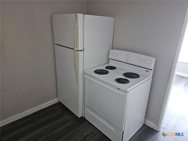 kitchen with white appliances and dark hardwood / wood-style floors