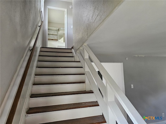 stairs with hardwood / wood-style floors