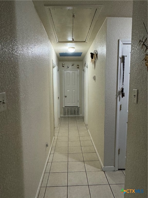 corridor with light tile patterned floors