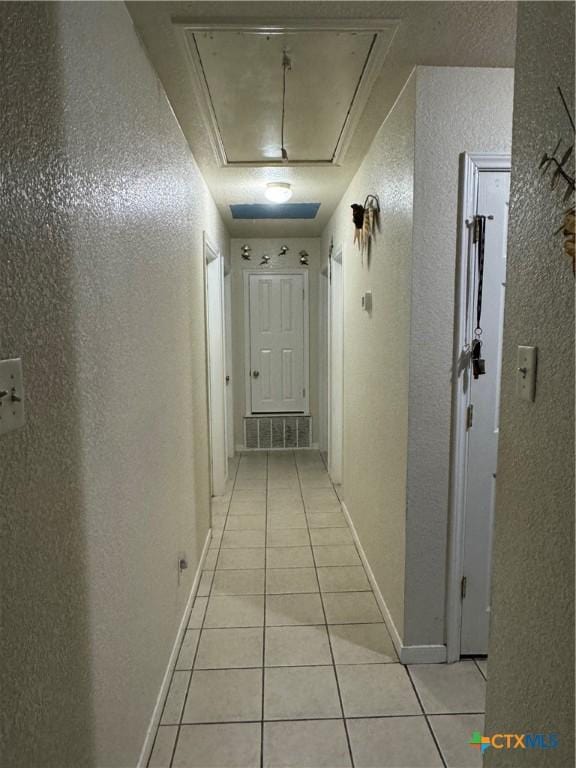 1617 S Harley Dr, Harker Heights, TX 76548 - hallway featuring attic access, a textured wall, and light tile patterned flooring