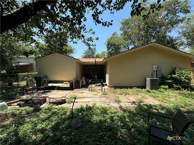 rear view of house with cooling unit and a patio area