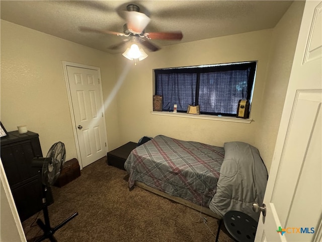 bedroom with dark colored carpet and ceiling fan