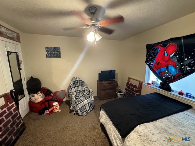 carpeted bedroom featuring a textured ceiling and ceiling fan