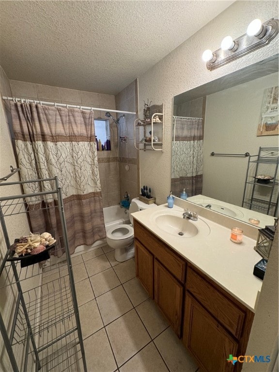 full bathroom featuring tile patterned flooring, a textured ceiling, shower / tub combo with curtain, vanity, and toilet