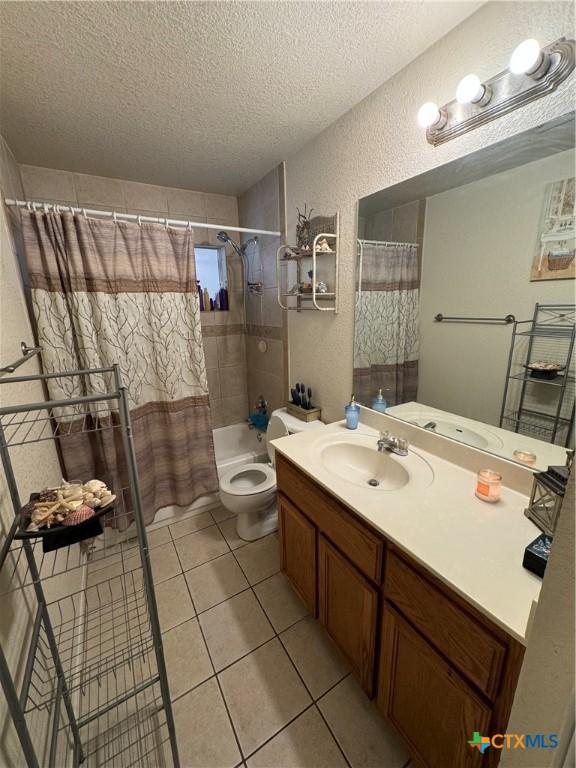 1617 S Harley Dr, Harker Heights, TX 76548 - full bathroom with a textured ceiling, vanity, a textured wall, shower / bath combo, and tile patterned flooring