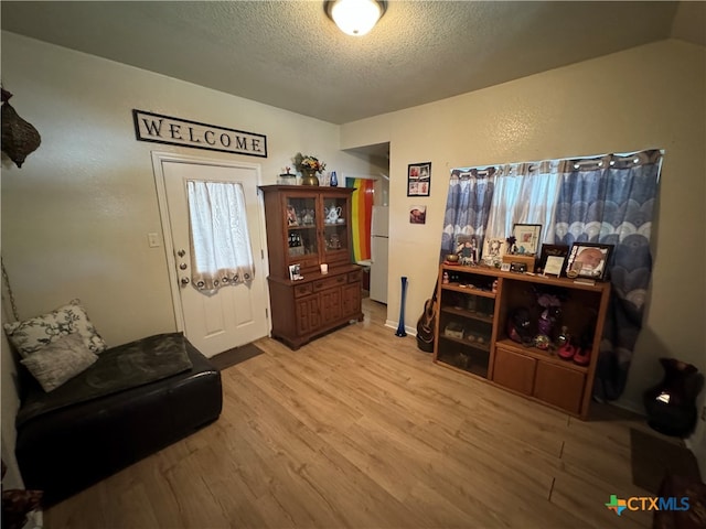 interior space with hardwood / wood-style floors and a textured ceiling