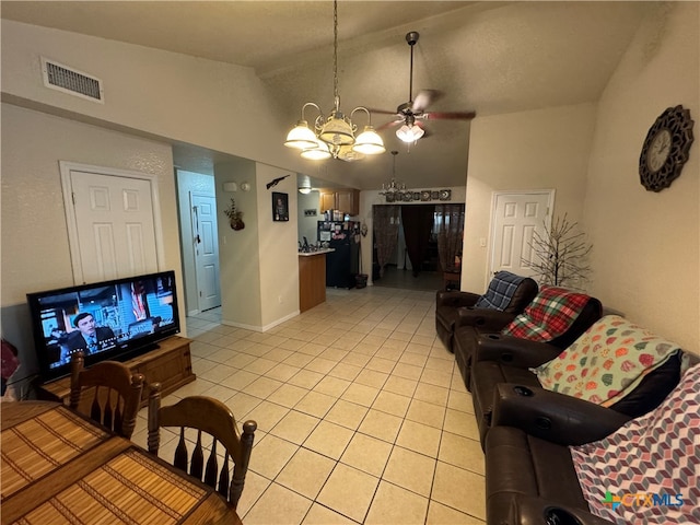 tiled living room featuring ceiling fan with notable chandelier and high vaulted ceiling