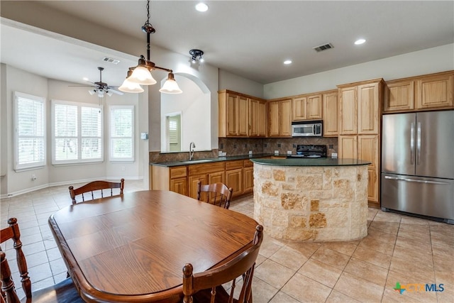 425 County Road 3830, San Antonio, TX 78253 - kitchen featuring stainless steel appliances, a sink, light tile patterned floors, decorative backsplash, and recessed lighting