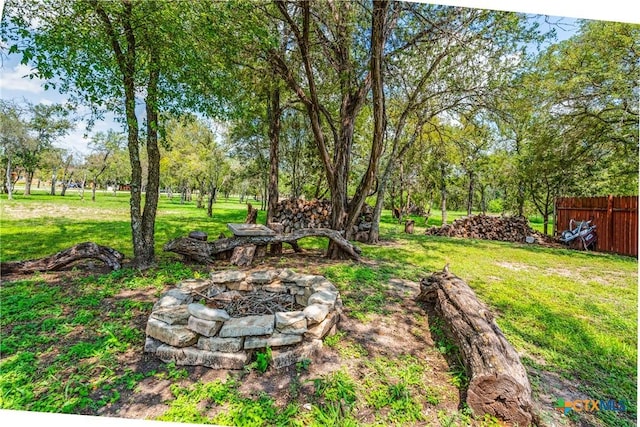 425 County Road 3830, San Antonio, TX 78253 - view of yard featuring an outdoor fire pit and view of wooded area