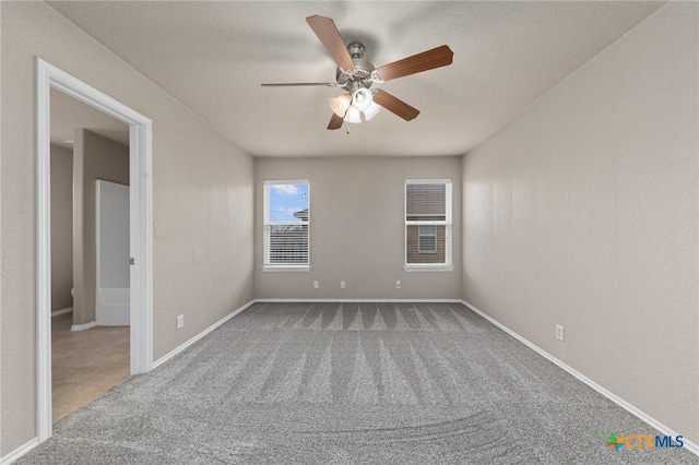 spare room with carpet floors and ceiling fan