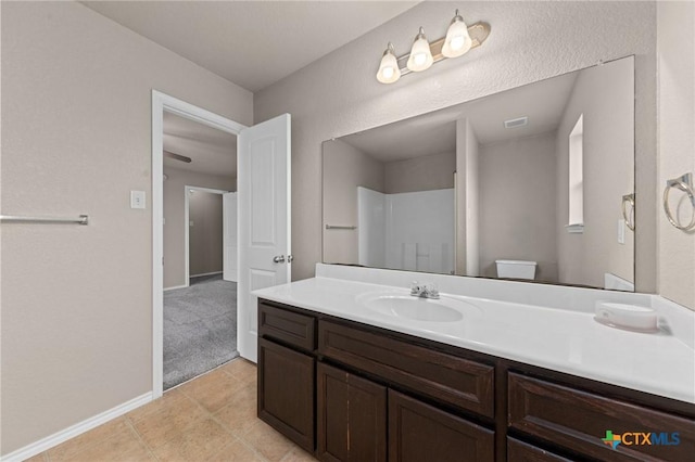 bathroom featuring vanity, toilet, and tile patterned flooring