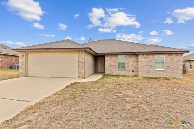 single story home with a garage and central air condition unit