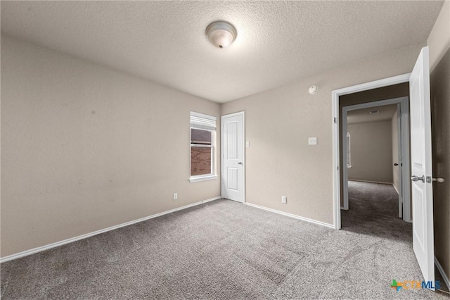 unfurnished bedroom featuring carpet and a textured ceiling