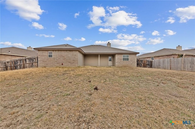 back of property featuring a lawn