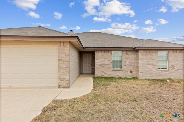 single story home featuring a garage and a front yard