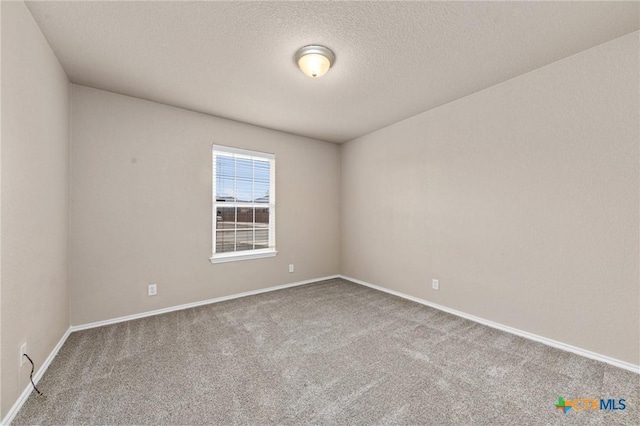 carpeted spare room featuring a textured ceiling