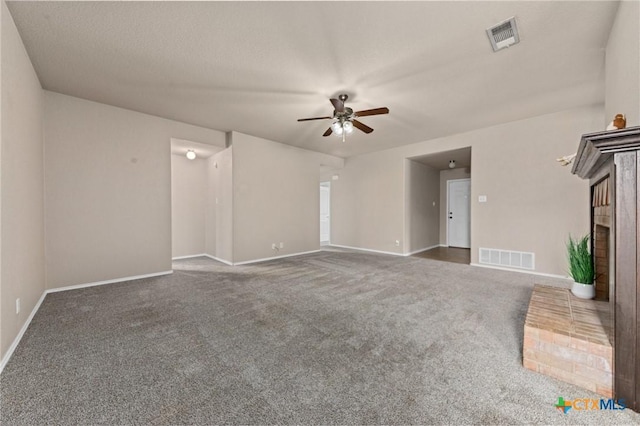 unfurnished living room featuring ceiling fan, dark carpet, and a textured ceiling