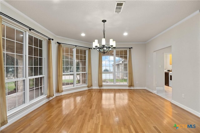 unfurnished dining area with ornamental molding, light hardwood / wood-style flooring, and a notable chandelier