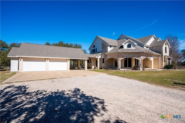 view of front of property with a garage, stone siding, and concrete driveway