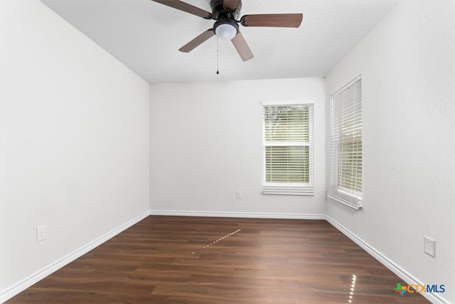 spare room with dark hardwood / wood-style floors and ceiling fan