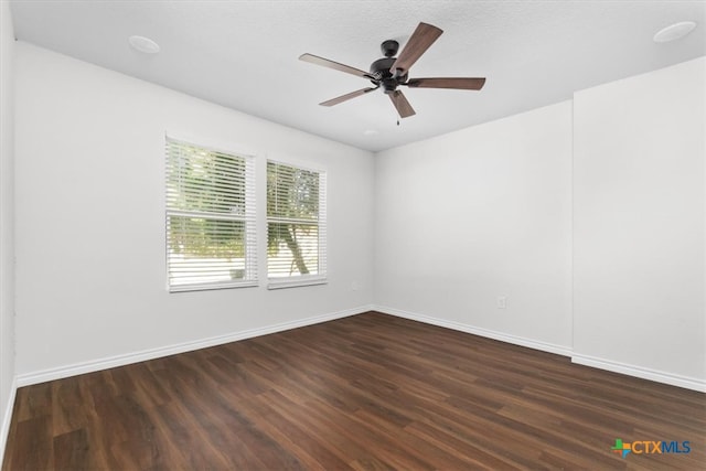 unfurnished room featuring ceiling fan, a textured ceiling, and dark hardwood / wood-style floors