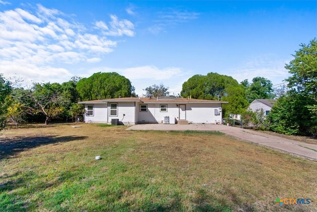 back of property featuring a patio, central air condition unit, and a yard