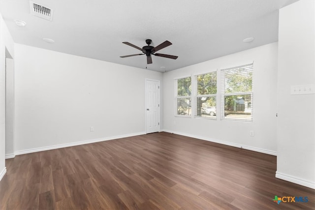 spare room featuring a textured ceiling, dark hardwood / wood-style floors, and ceiling fan