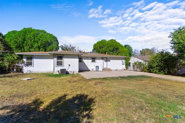 back of property featuring a patio and a yard