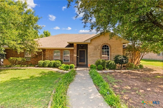 509 Sapphire Blvd, Hewitt, TX 76643 - ranch-style home with a front yard, a shingled roof, stone siding, and brick siding