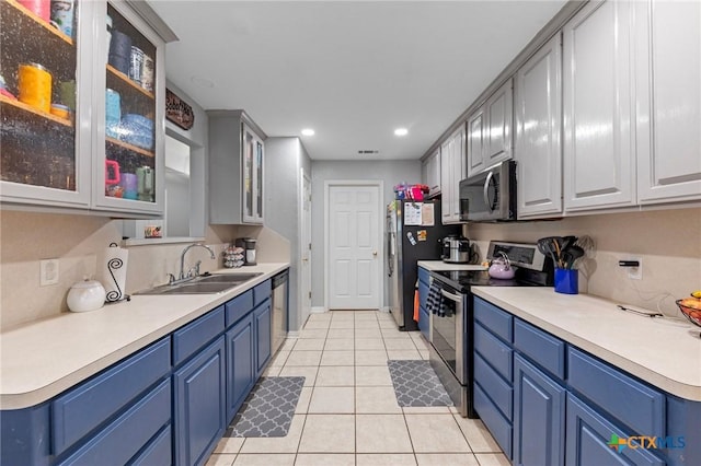 509 Sapphire Blvd, Hewitt, TX 76643 - kitchen featuring appliances with stainless steel finishes, a sink, blue cabinetry, light tile patterned floors, and light countertops
