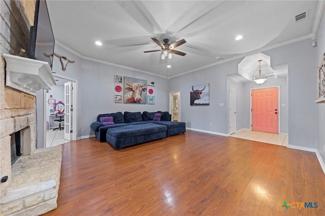 509 Sapphire Blvd, Hewitt, TX 76643 - living area featuring ornamental molding, ceiling fan, wood finished floors, recessed lighting, and a stone fireplace