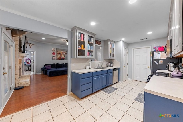 509 Sapphire Blvd, Hewitt, TX 76643 - kitchen featuring a sink, blue cabinetry, appliances with stainless steel finishes, light countertops, and light tile patterned floors