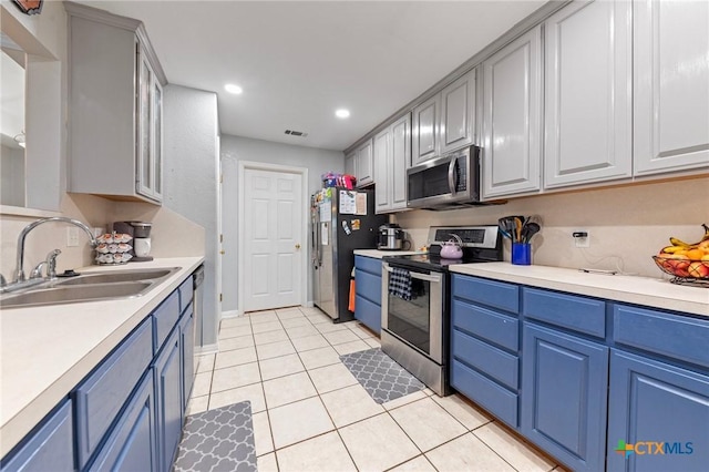 509 Sapphire Blvd, Hewitt, TX 76643 - kitchen featuring stainless steel appliances, a sink, blue cabinets, light countertops, and recessed lighting