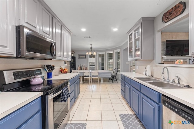509 Sapphire Blvd, Hewitt, TX 76643 - kitchen featuring appliances with stainless steel finishes, blue cabinetry, a sink, ornamental molding, and recessed lighting