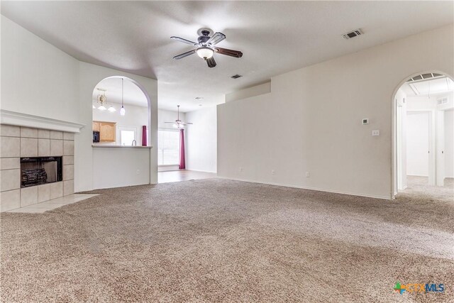 2154 Hidden Mdw, New Braunfels, TX 78130 - unfurnished living room with visible vents, a ceiling fan, arched walkways, and carpet floors