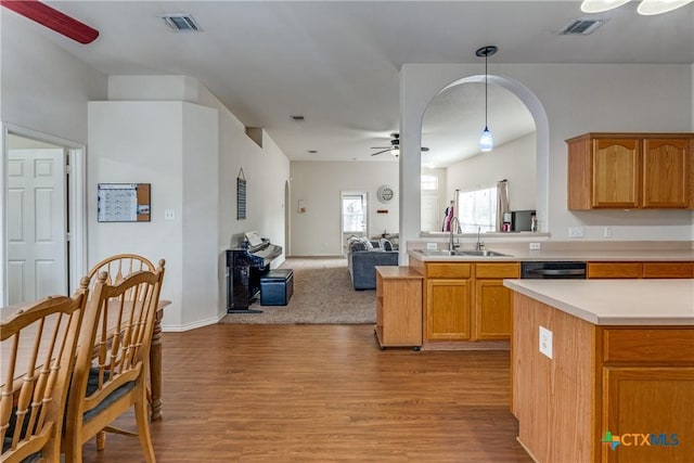 kitchen with pendant lighting, sink, dishwasher, ceiling fan, and light hardwood / wood-style floors