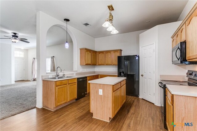 2154 Hidden Mdw, New Braunfels, TX 78130 - kitchen featuring a center island, light countertops, black appliances, a sink, and wood finished floors