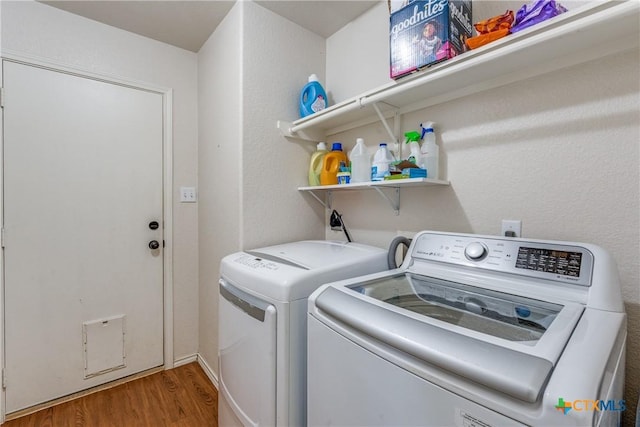 laundry area featuring wood-type flooring and washer and dryer