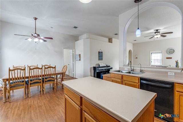 kitchen featuring sink, a center island, hanging light fixtures, dishwasher, and ceiling fan