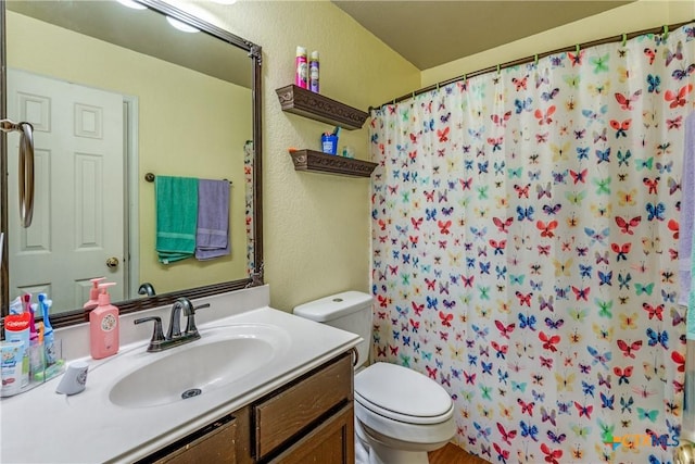 bathroom with vanity, toilet, and a shower with shower curtain